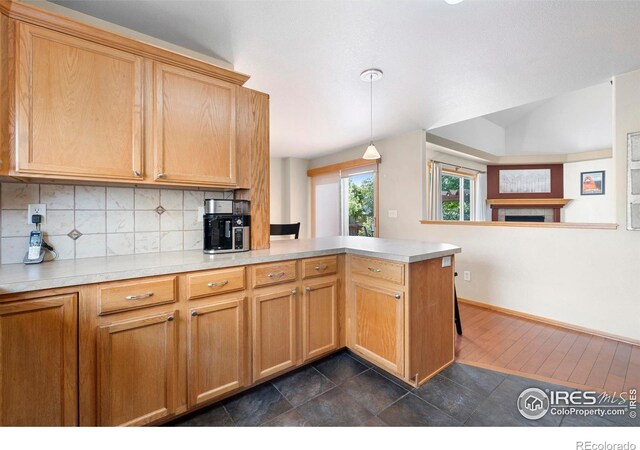 1502 Westfield Dr, Fort Collins, CO 80526 - kitchen featuring a peninsula, light countertops, backsplash, and a tiled fireplace