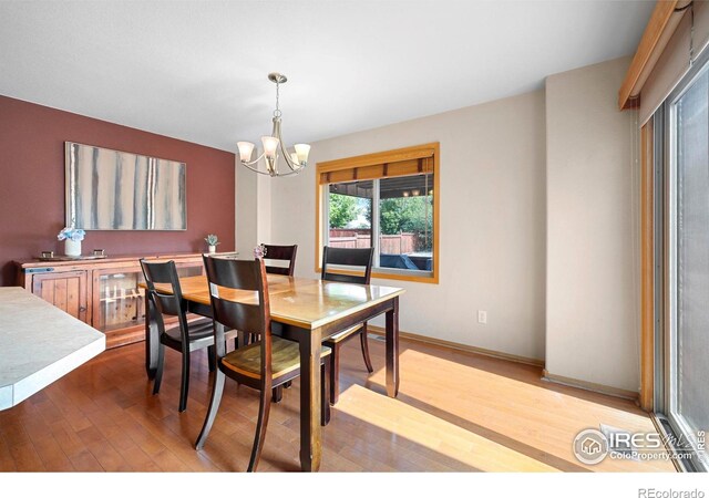 1502 Westfield Dr, Fort Collins, CO 80526 - dining room featuring a chandelier, wood finished floors, and baseboards