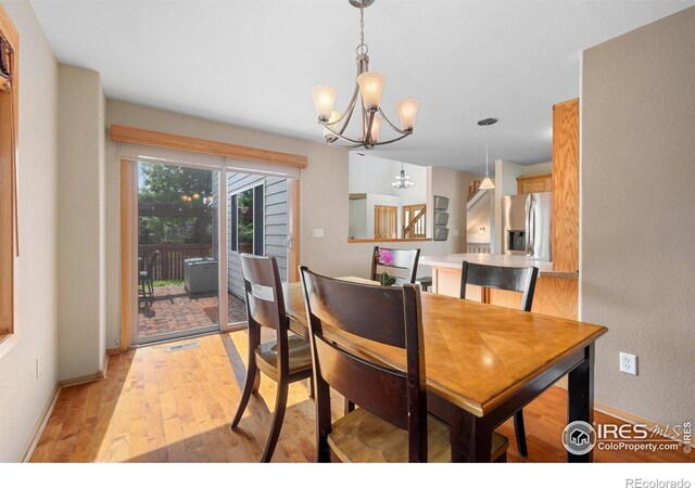 1502 Westfield Dr, Fort Collins, CO 80526 - dining room featuring a chandelier, light wood-style flooring, and baseboards