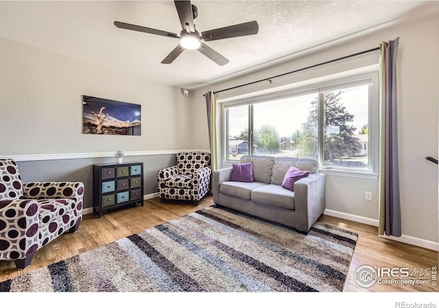 2447 E 100th Way, Thornton, CO 80229 - living area with baseboards, wood finished floors, and ceiling fan