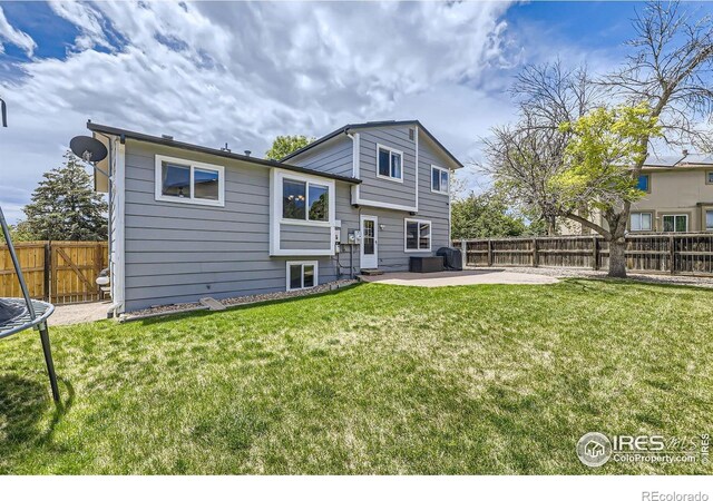 2447 E 100th Way, Thornton, CO 80229 - back of house with a patio area and a trampoline