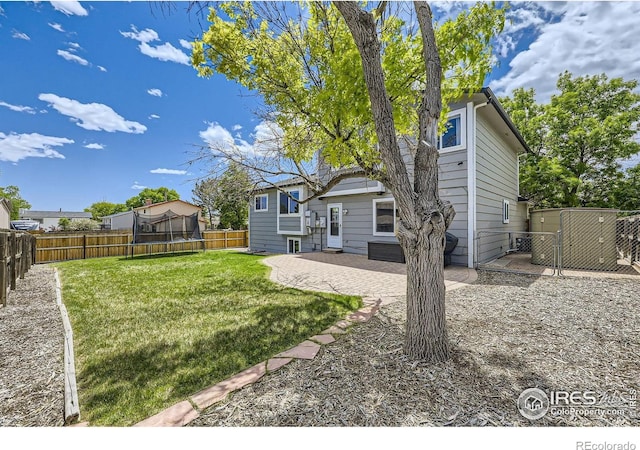 2447 E 100th Way, Thornton, CO 80229 - view of yard featuring a trampoline, a patio, and a gate