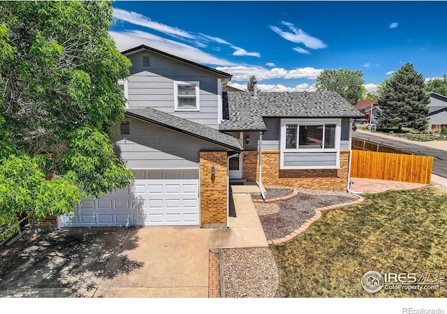 2447 E 100th Way, Thornton, CO 80229 - view of front of house featuring concrete driveway, brick siding, a shingled roof, and a garage
