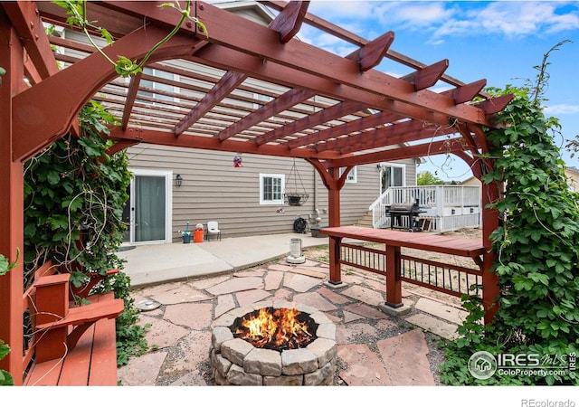 3328 Wild W Ln, Wellington, CO 80549 - view of patio with an outdoor fire pit, a wooden deck, and a pergola