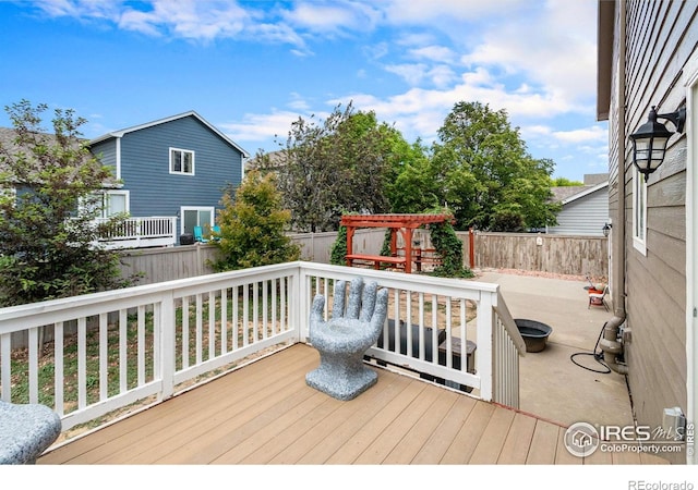 3328 Wild W Ln, Wellington, CO 80549 - wooden terrace featuring a fenced backyard and a patio area