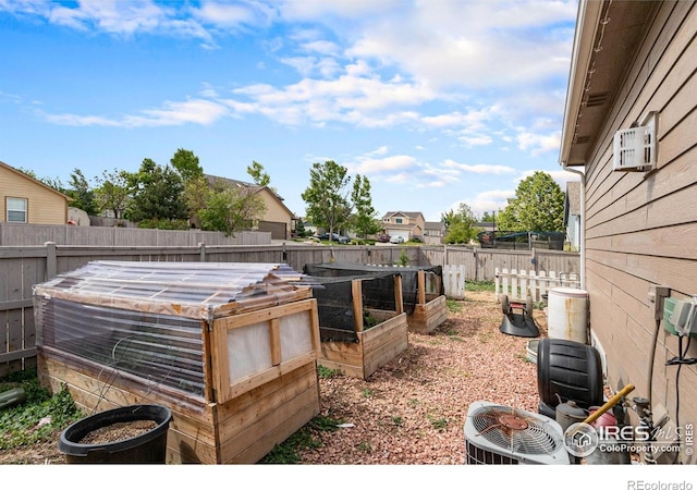3328 Wild W Ln, Wellington, CO 80549 - fenced backyard featuring a garden and a wall mounted air conditioner