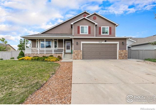 3328 Wild W Ln, Wellington, CO 80549 - view of front of house with a porch, an attached garage, driveway, and brick siding