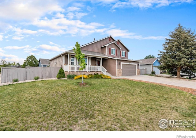 3328 Wild W Ln, Wellington, CO 80549 - traditional home featuring a porch, driveway, and a garage