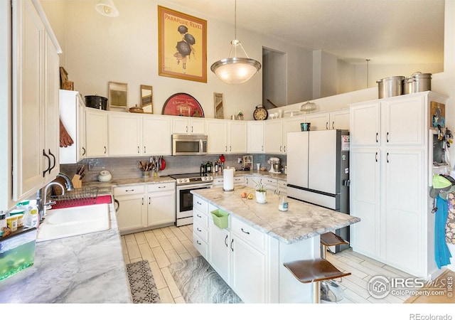 3328 Wild W Ln, Wellington, CO 80549 - kitchen with stainless steel appliances, tasteful backsplash, white cabinetry, a center island, and light stone countertops