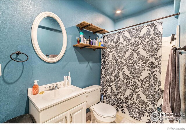 3328 Wild W Ln, Wellington, CO 80549 - bathroom with vanity, a textured wall, and curtained shower
