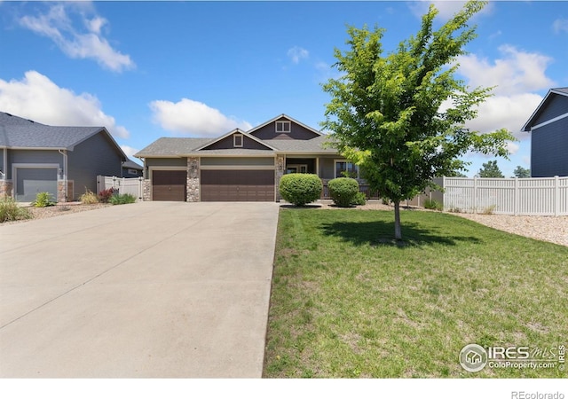 5869 Vinca Ave, Longmont, CO 80504 - view of front of home featuring a garage and concrete driveway