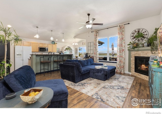 5869 Vinca Ave, Longmont, CO 80504 - living room featuring a ceiling fan, a tile fireplace, wood finished floors, lofted ceiling, and baseboards