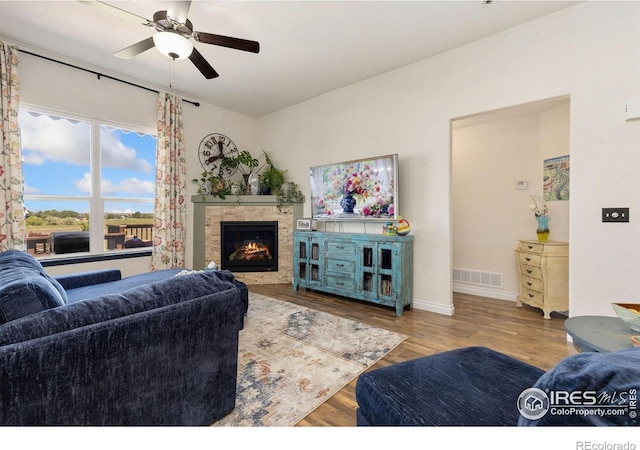 5869 Vinca Ave, Longmont, CO 80504 - living area with a fireplace, wood finished floors, a ceiling fan, and baseboards