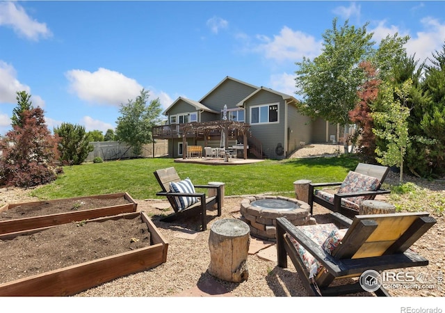 5869 Vinca Ave, Longmont, CO 80504 - view of yard featuring an outdoor fire pit, a patio, a deck, a vegetable garden, and stairway