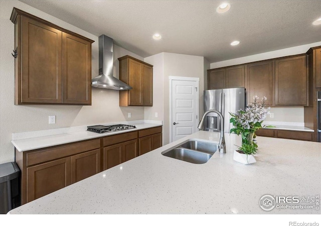 2150 Crop Row Dr, Windsor, CO 80550 - kitchen with wall chimney range hood, a sink, stainless steel appliances, light stone counters, and recessed lighting