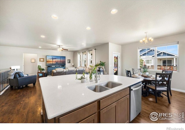 2150 Crop Row Dr, Windsor, CO 80550 - kitchen with a sink, stainless steel dishwasher, open floor plan, a chandelier, and dark wood-style flooring