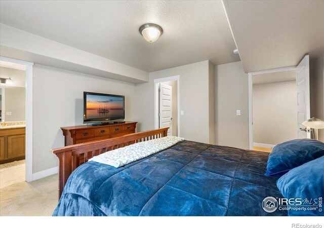 2150 Crop Row Dr, Windsor, CO 80550 - bedroom with light colored carpet, baseboards, and ensuite bathroom