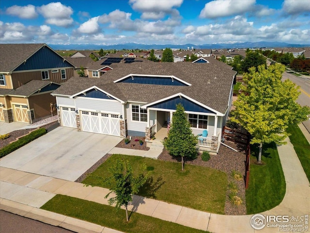 2150 Crop Row Dr, Windsor, CO 80550 - view of front of home featuring stone siding, an attached garage, a residential view, and a shingled roof