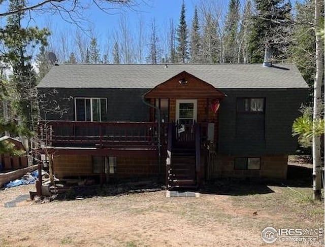 100 Santee Ct, Red Feather Lakes, CO 80545 - view of front of property with a wooden deck and roof with shingles