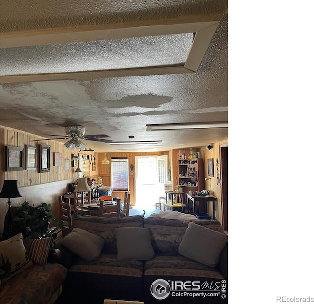 100 Santee Ct, Red Feather Lakes, CO 80545 - carpeted living area featuring wooden walls and ceiling fan