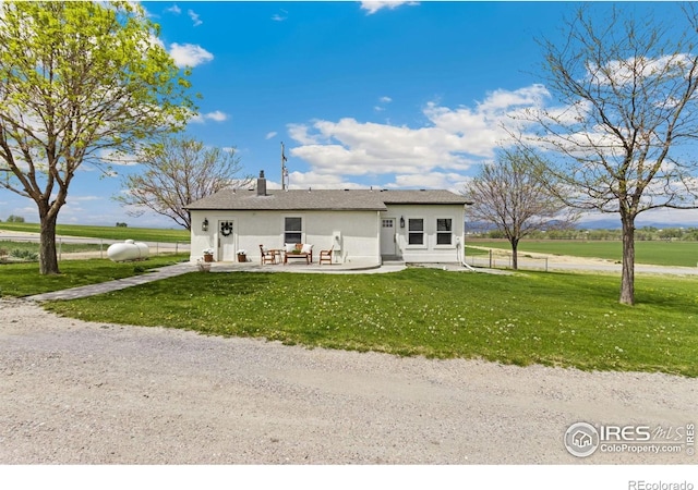 19810 County Road 1, Berthoud, CO 80513 - rear view of property with stucco siding and a patio area