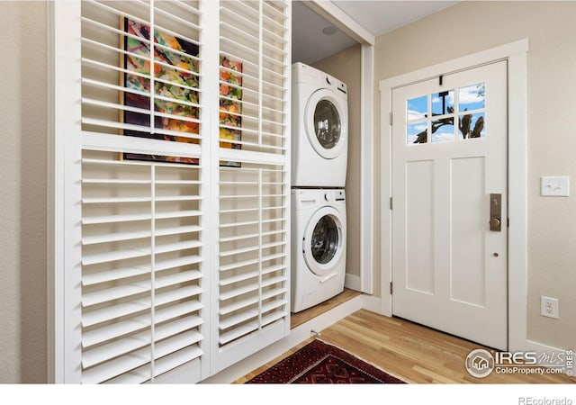 19810 County Road 1, Berthoud, CO 80513 - washroom with stacked washing machine and dryer and wood finished floors