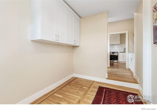 19810 County Road 1, Berthoud, CO 80513 - laundry area with light wood-style floors and baseboards