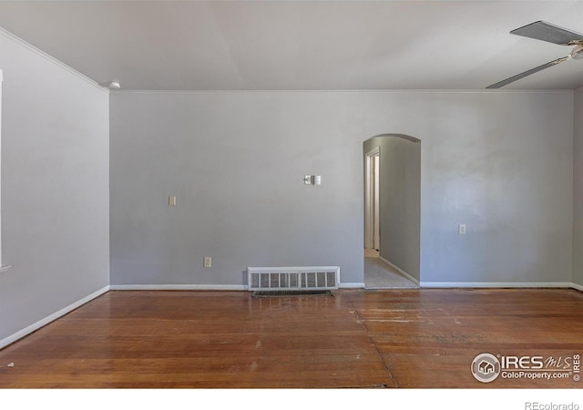 29 Marshall Pl, Longmont, CO 80504 - empty room featuring arched walkways, wood finished floors, baseboards, and ornamental molding