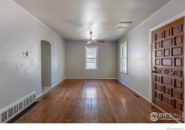 29 Marshall Pl, Longmont, CO 80504 - empty room with hardwood / wood-style floors, arched walkways, a ceiling fan, baseboards, and crown molding