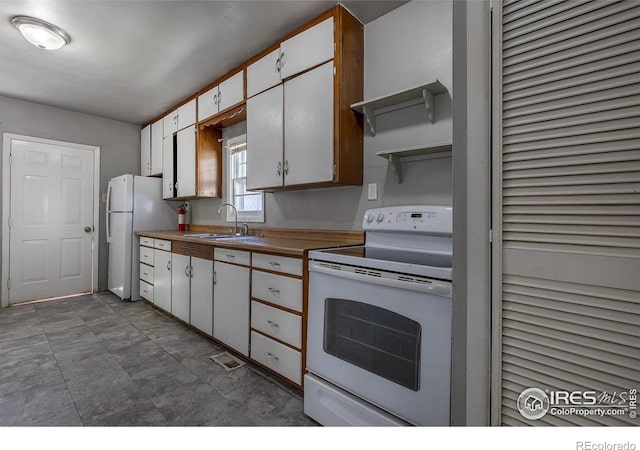 29 Marshall Pl, Longmont, CO 80504 - kitchen featuring white appliances, a sink, open shelves, white cabinets, and light countertops