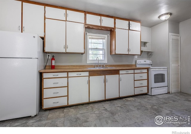 29 Marshall Pl, Longmont, CO 80504 - kitchen featuring white appliances, a sink, light countertops, and white cabinetry