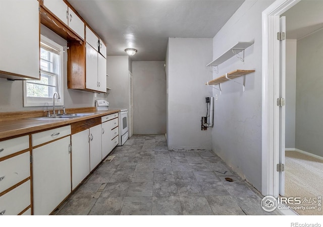 29 Marshall Pl, Longmont, CO 80504 - kitchen featuring a sink, white range with electric stovetop, white cabinetry, open shelves, and stone finish floors