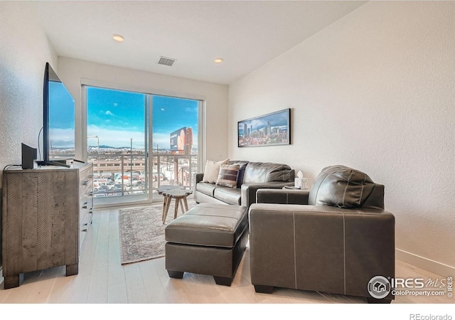 1616 S Broadway Unit 304, Denver, CO 80210 - living area with light wood-style floors, a textured wall, recessed lighting, and baseboards