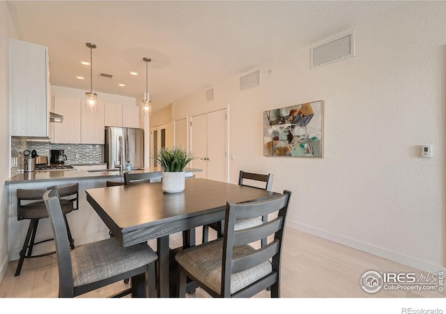 1616 S Broadway Unit 304, Denver, CO 80210 - dining area with light wood-style floors, baseboards, and recessed lighting
