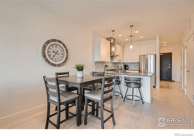 1616 S Broadway Unit 304, Denver, CO 80210 - dining space with light wood-type flooring, recessed lighting, and baseboards