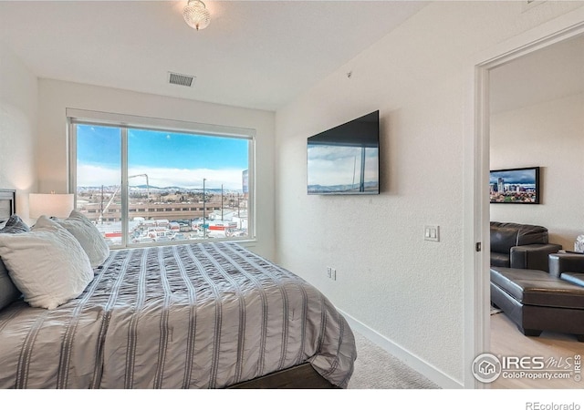 1616 S Broadway Unit 304, Denver, CO 80210 - carpeted bedroom with baseboards and a textured wall