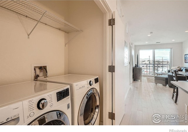 1616 S Broadway Unit 304, Denver, CO 80210 - washroom featuring separate washer and dryer, recessed lighting, and light wood-style floors