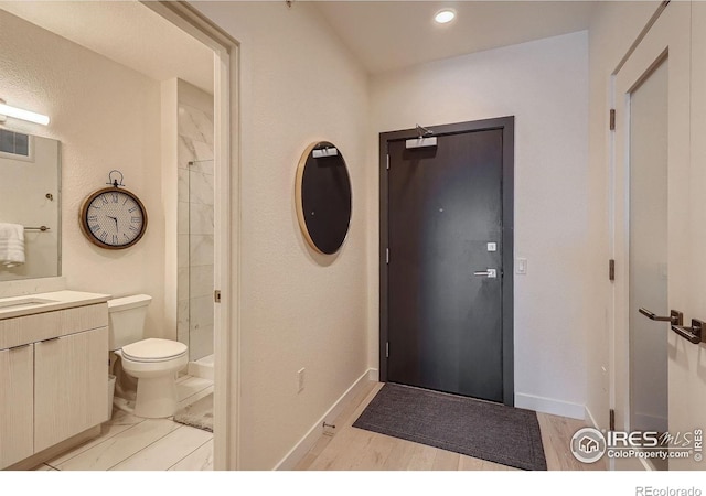 1616 S Broadway Unit 304, Denver, CO 80210 - bathroom with toilet, vanity, a shower, and baseboards