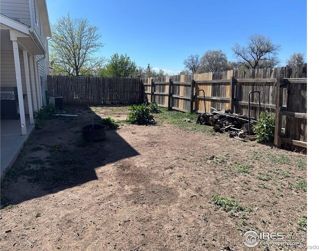 309 Ash Ct, Evans, CO 80620 - view of yard featuring central air condition unit and an outdoor fire pit