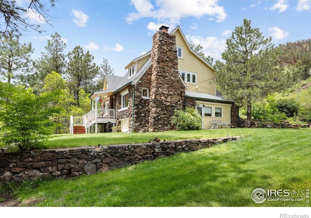 1031 W US Highway 34, Loveland, CO 80537 - back of house with a chimney, a lawn, and stone siding