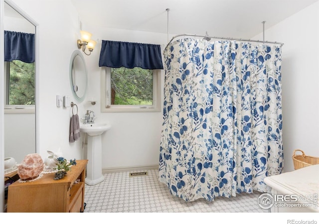 1031 W US Highway 34, Loveland, CO 80537 - full bathroom with a sink, tile patterned floors, and curtained shower