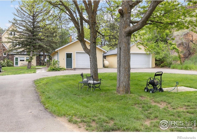1031 W US Highway 34, Loveland, CO 80537 - view of front of property with a garage, an outdoor structure, and a front yard