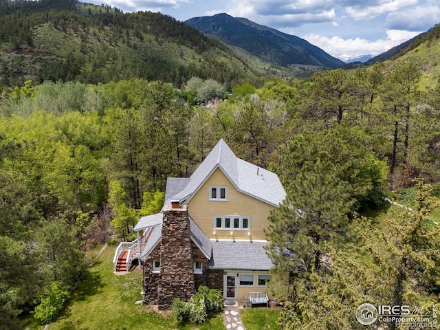 1031 W US Highway 34, Loveland, CO 80537 - aerial view of property and surrounding area with a heavily wooded area and a mountainous background