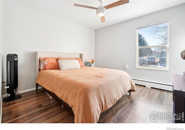 3431 Stover St Unit E-513, Fort Collins, CO 80525 - bedroom with baseboard heating, wood finished floors, and ceiling fan