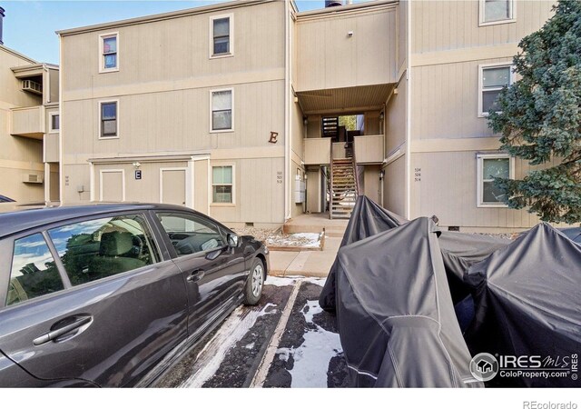 3431 Stover St Unit E-513, Fort Collins, CO 80525 - view of building exterior with stairway and uncovered parking