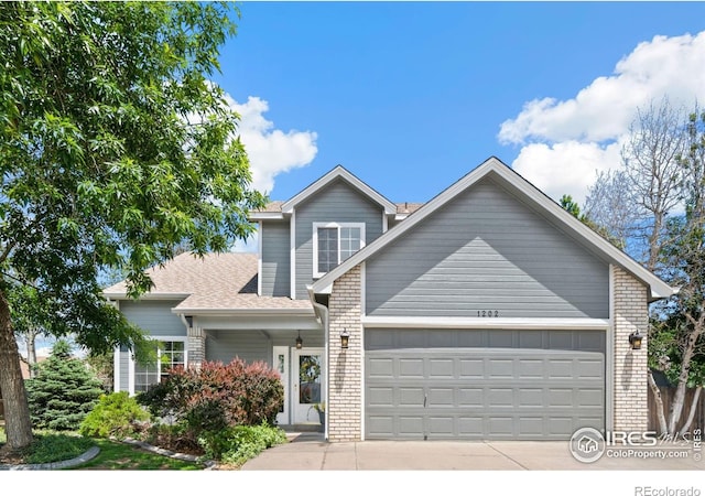 1202 Creekwood Ct, Windsor, CO 80550 - traditional home featuring brick siding, a garage, driveway, and a shingled roof