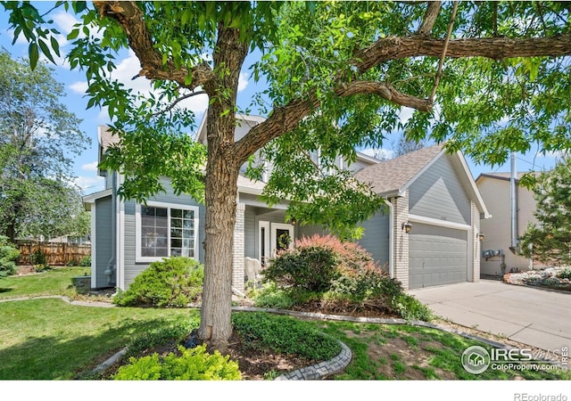 1202 Creekwood Ct, Windsor, CO 80550 - view of property hidden behind natural elements featuring an attached garage, concrete driveway, and brick siding