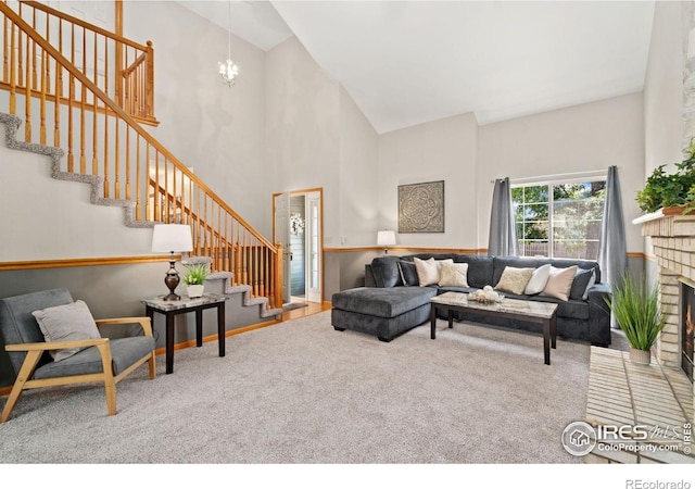 1202 Creekwood Ct, Windsor, CO 80550 - carpeted living room with high vaulted ceiling, stairs, a chandelier, and a fireplace