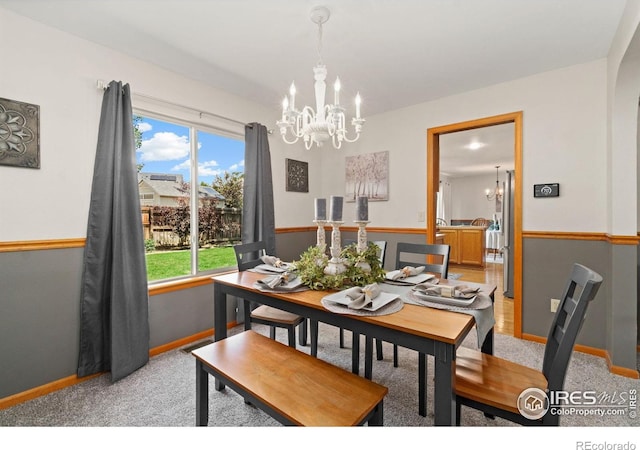 1202 Creekwood Ct, Windsor, CO 80550 - dining area with a chandelier, light carpet, and baseboards