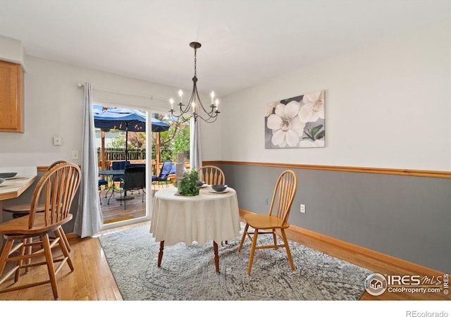 1202 Creekwood Ct, Windsor, CO 80550 - dining room with light wood finished floors and a chandelier